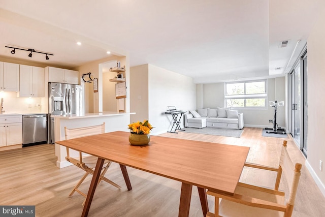 dining area with light hardwood / wood-style flooring