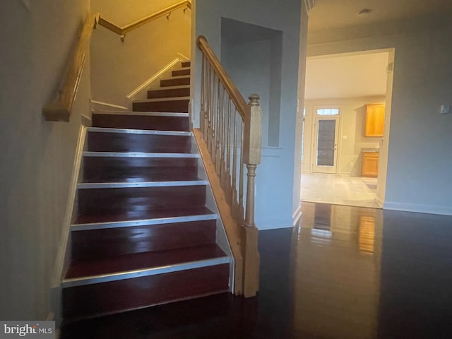 stairway with hardwood / wood-style flooring