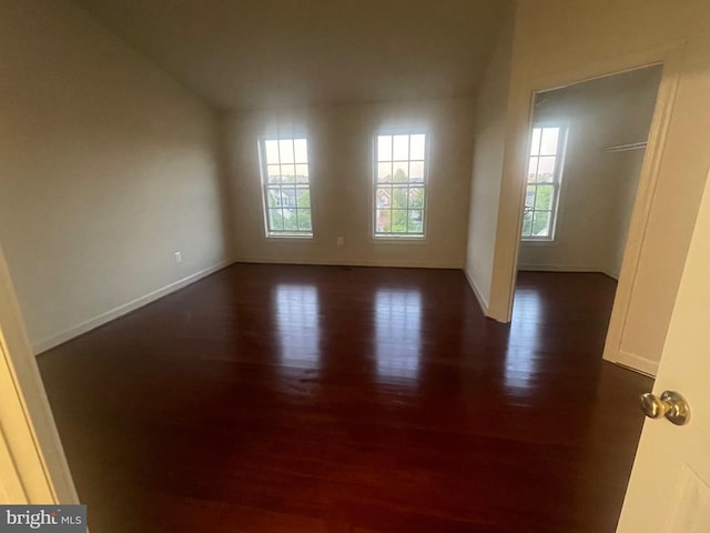 empty room featuring dark hardwood / wood-style flooring