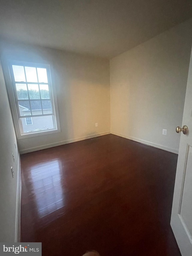 empty room featuring dark wood-type flooring