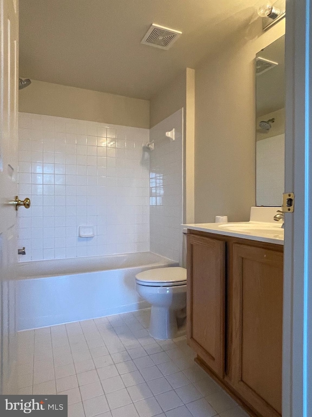 full bathroom with tile patterned flooring, vanity, toilet, and tiled shower / bath