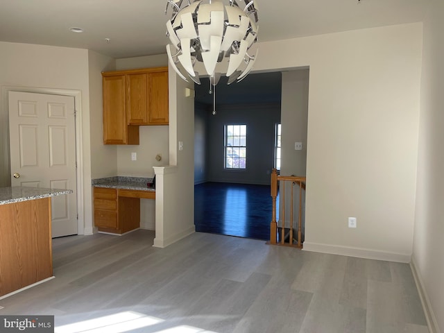 kitchen featuring light stone countertops and light hardwood / wood-style flooring