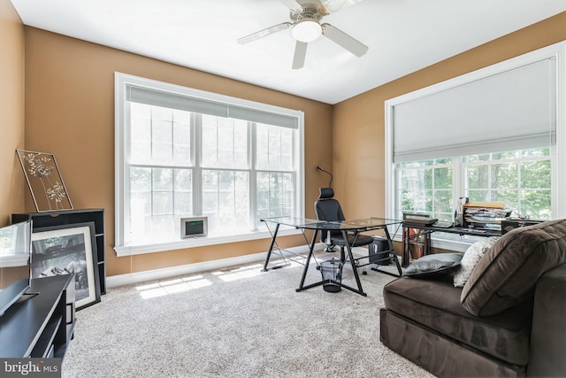 carpeted office featuring ceiling fan