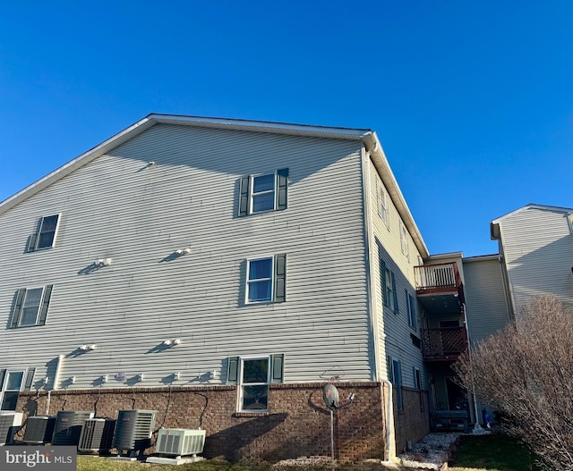 rear view of house featuring central air condition unit