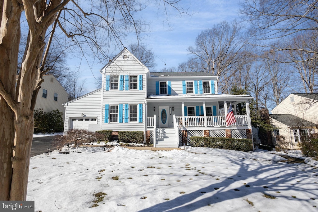 view of front facade with covered porch and a garage