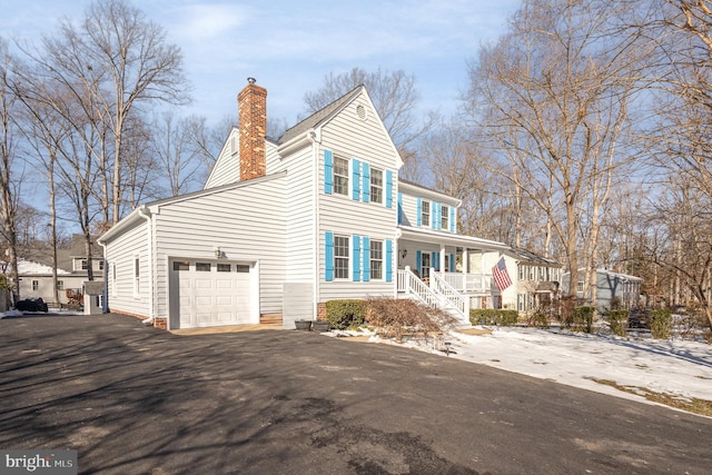 view of front facade with a garage and covered porch