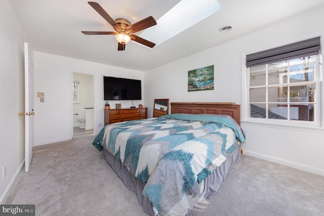 carpeted bedroom featuring ceiling fan and ensuite bathroom