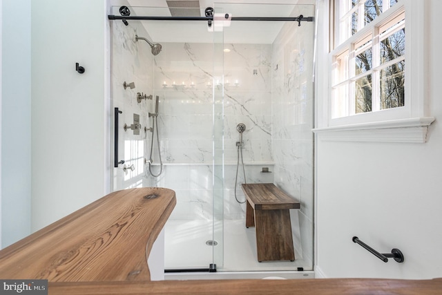 bathroom featuring a shower with shower door