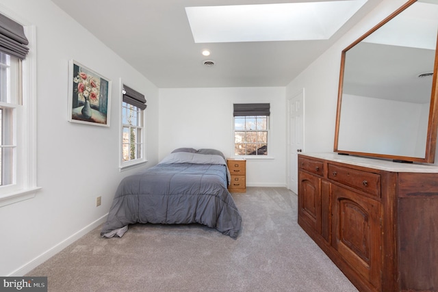 bedroom featuring multiple windows and light carpet