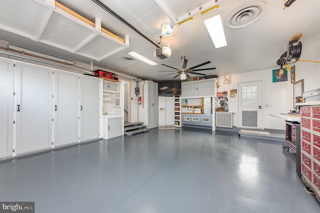 garage featuring a garage door opener and ceiling fan