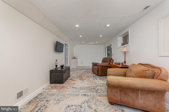 living room with a drop ceiling