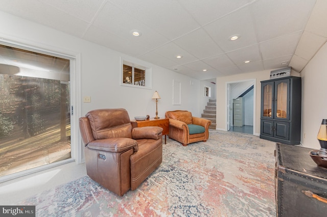 living room featuring a paneled ceiling