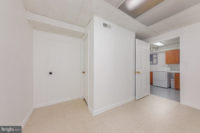 interior space with washer / clothes dryer and a paneled ceiling