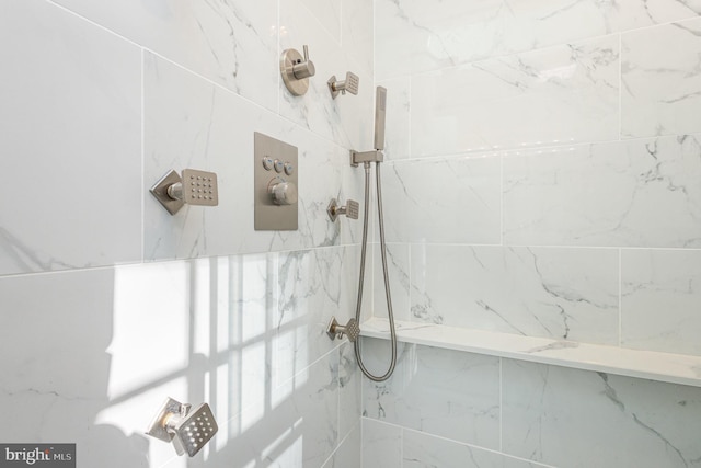 bathroom with tiled shower