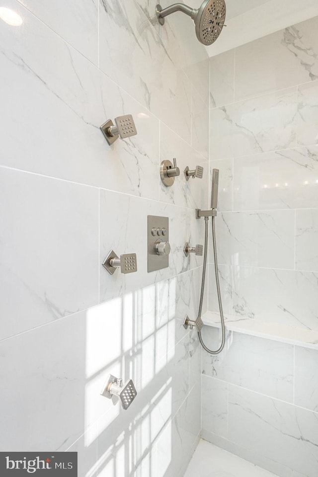 bathroom with tiled shower