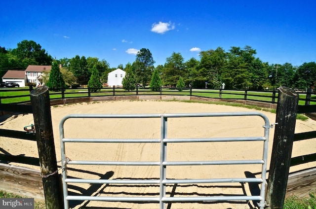 view of gate with a rural view