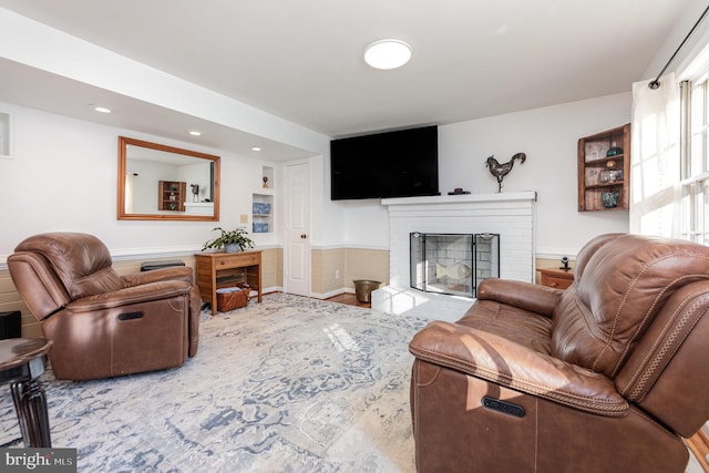 living room featuring a brick fireplace