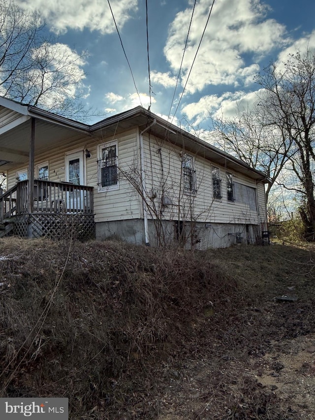 view of side of property with covered porch