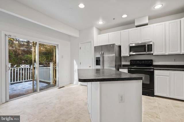 kitchen featuring white cabinetry, a center island, and appliances with stainless steel finishes