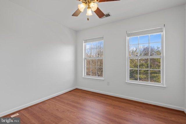 spare room featuring hardwood / wood-style floors and ceiling fan