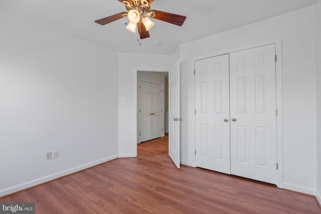 unfurnished bedroom with light hardwood / wood-style flooring, a closet, and ceiling fan