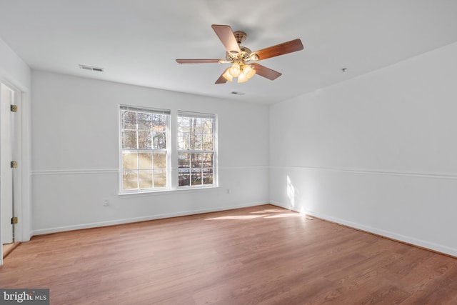 spare room with ceiling fan and light wood-type flooring