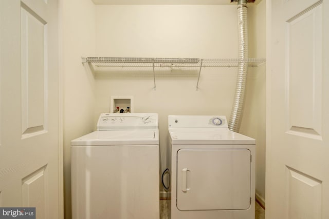 clothes washing area featuring washer and dryer