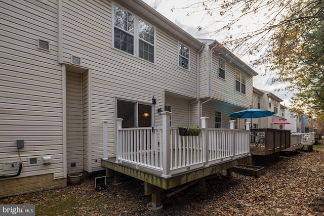 back of property with a wooden deck