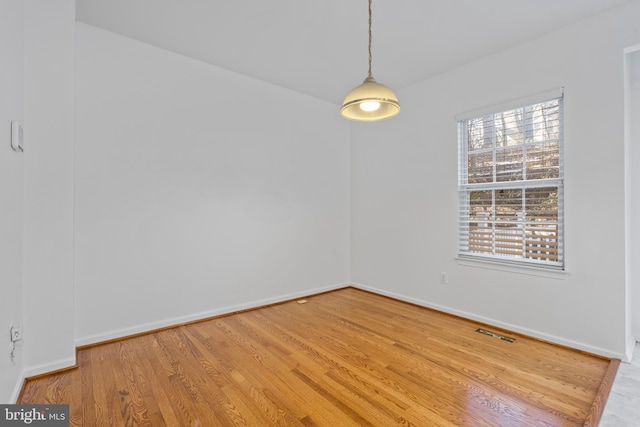 empty room with hardwood / wood-style flooring