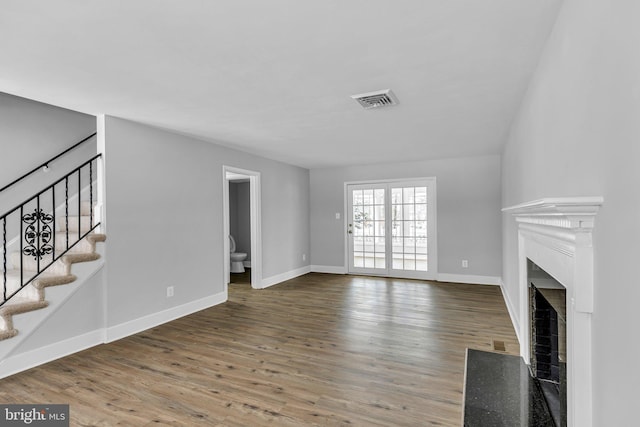 unfurnished living room featuring wood-type flooring