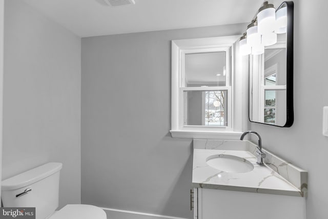 bathroom featuring vanity and toilet