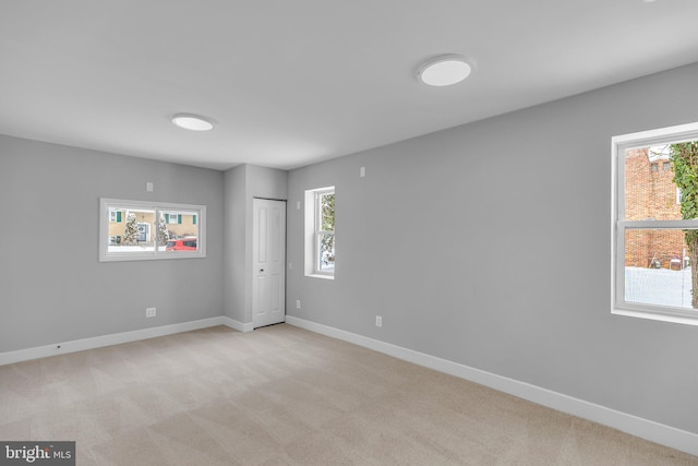 unfurnished room with light colored carpet