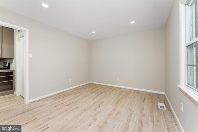 spare room with light hardwood / wood-style floors