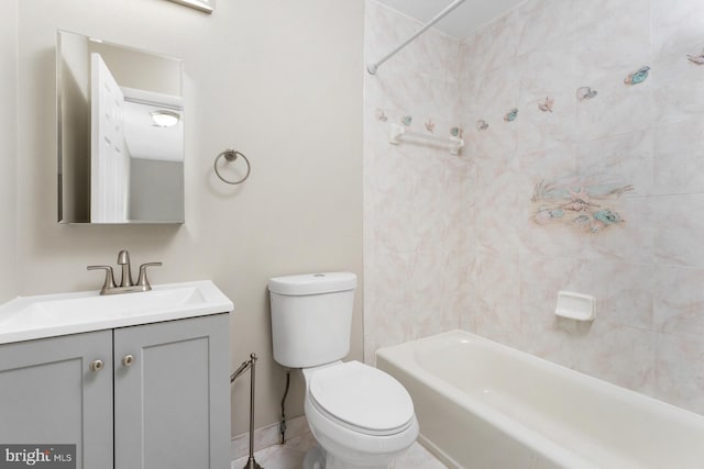 full bathroom featuring tiled shower / bath, vanity, and toilet