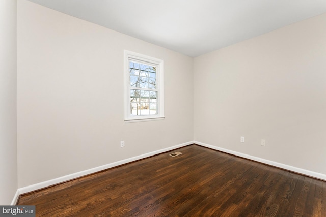 spare room with hardwood / wood-style floors