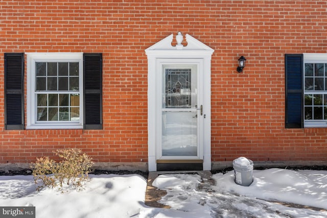 view of snow covered property entrance