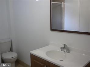 bathroom featuring toilet and vanity