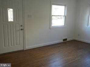 entryway featuring dark wood-style floors, visible vents, and baseboards