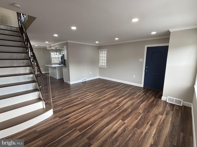 unfurnished living room with a healthy amount of sunlight, dark hardwood / wood-style flooring, and crown molding