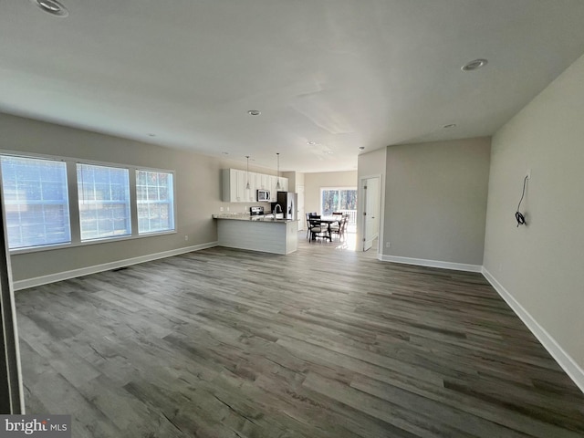 unfurnished living room featuring dark wood-type flooring