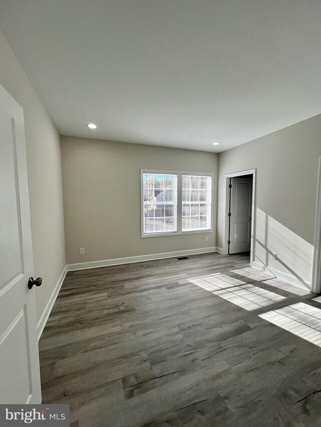 spare room with wood-type flooring