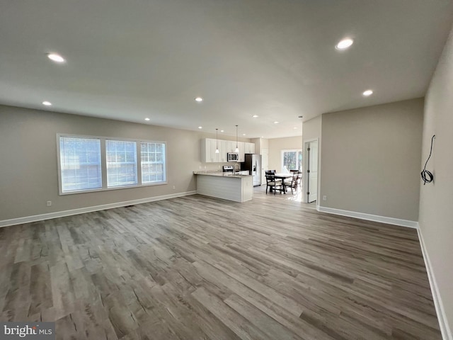 unfurnished living room with hardwood / wood-style flooring