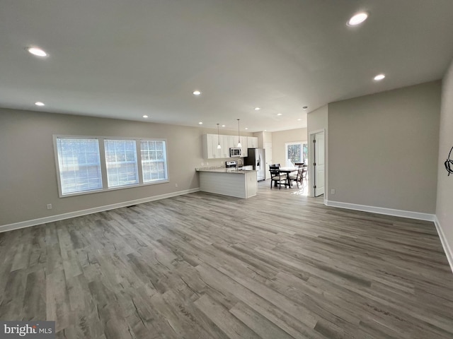 unfurnished living room featuring hardwood / wood-style floors