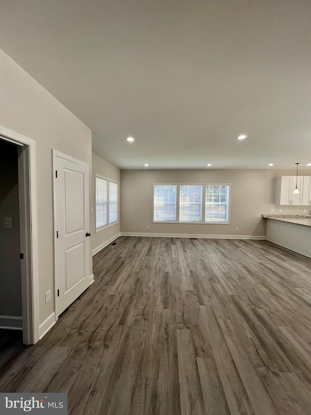 unfurnished living room featuring dark hardwood / wood-style flooring