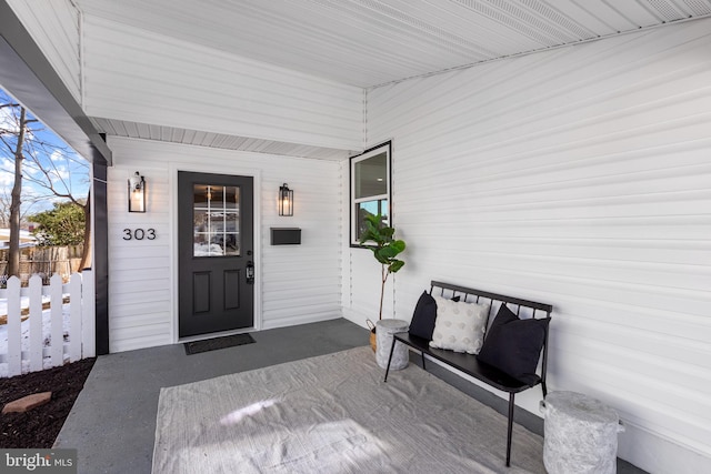 view of exterior entry with covered porch