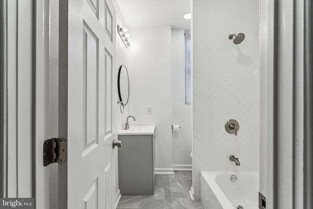 bathroom with vanity and tiled shower / bath combo