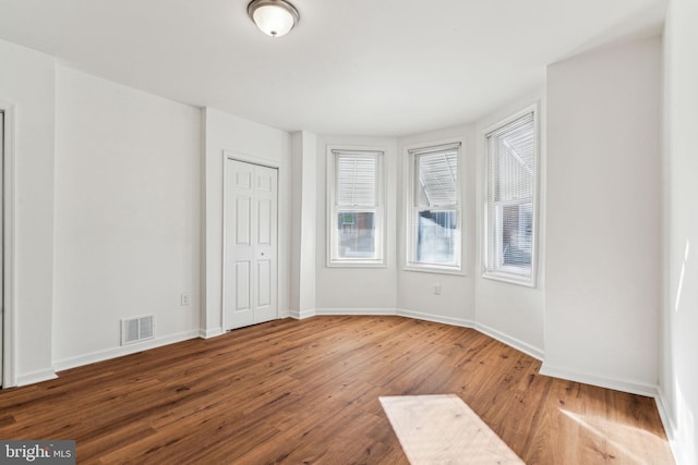 empty room with hardwood / wood-style flooring