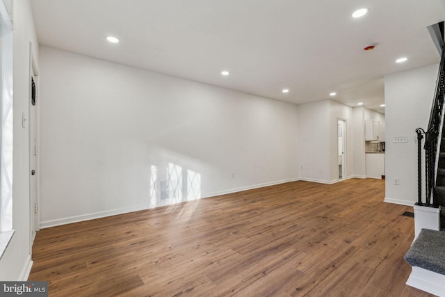 unfurnished living room featuring hardwood / wood-style floors