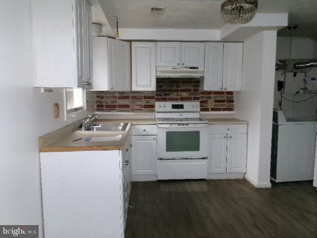 kitchen featuring white range with electric cooktop, decorative backsplash, white cabinetry, and sink