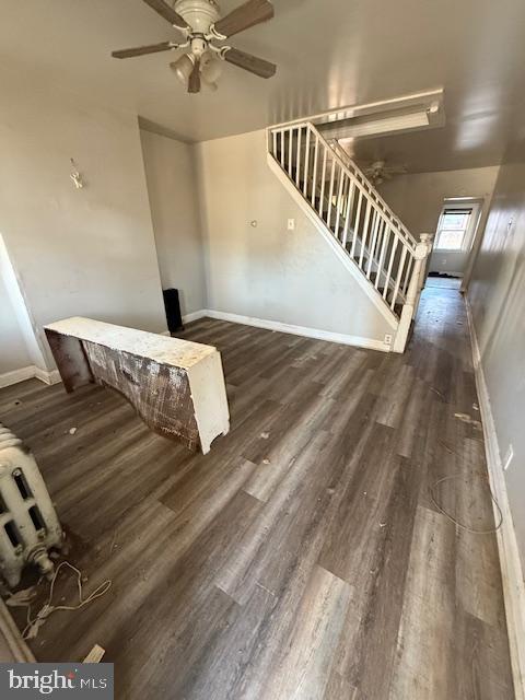 interior space with ceiling fan and dark hardwood / wood-style floors